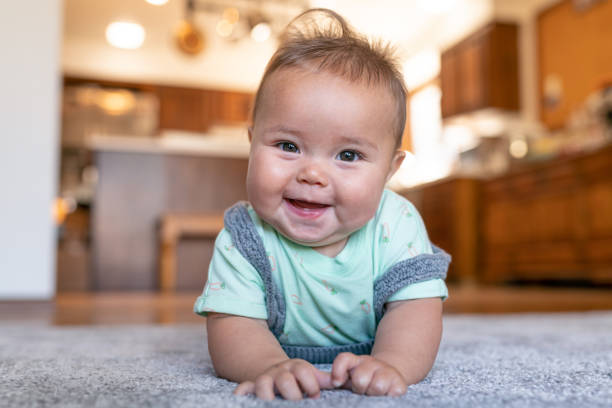 Baby lying on carpet | Brian's Flooring & Design