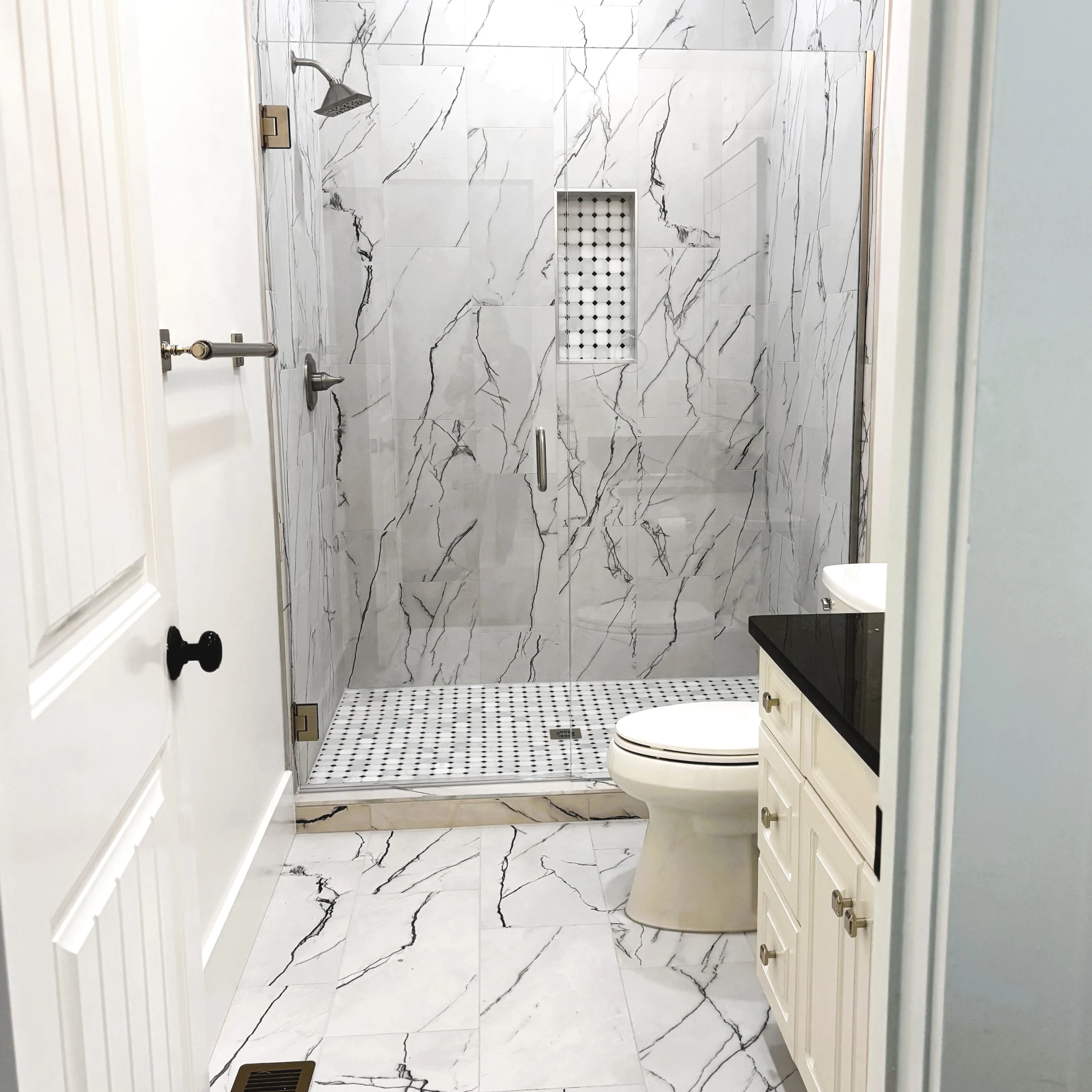 Tile shower, floor, and stone vanity