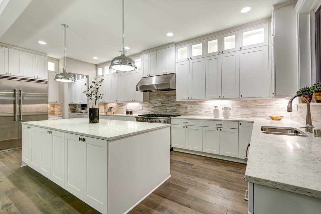Kitchen with a stylish countertop, cabinetry, and coordinating flooring